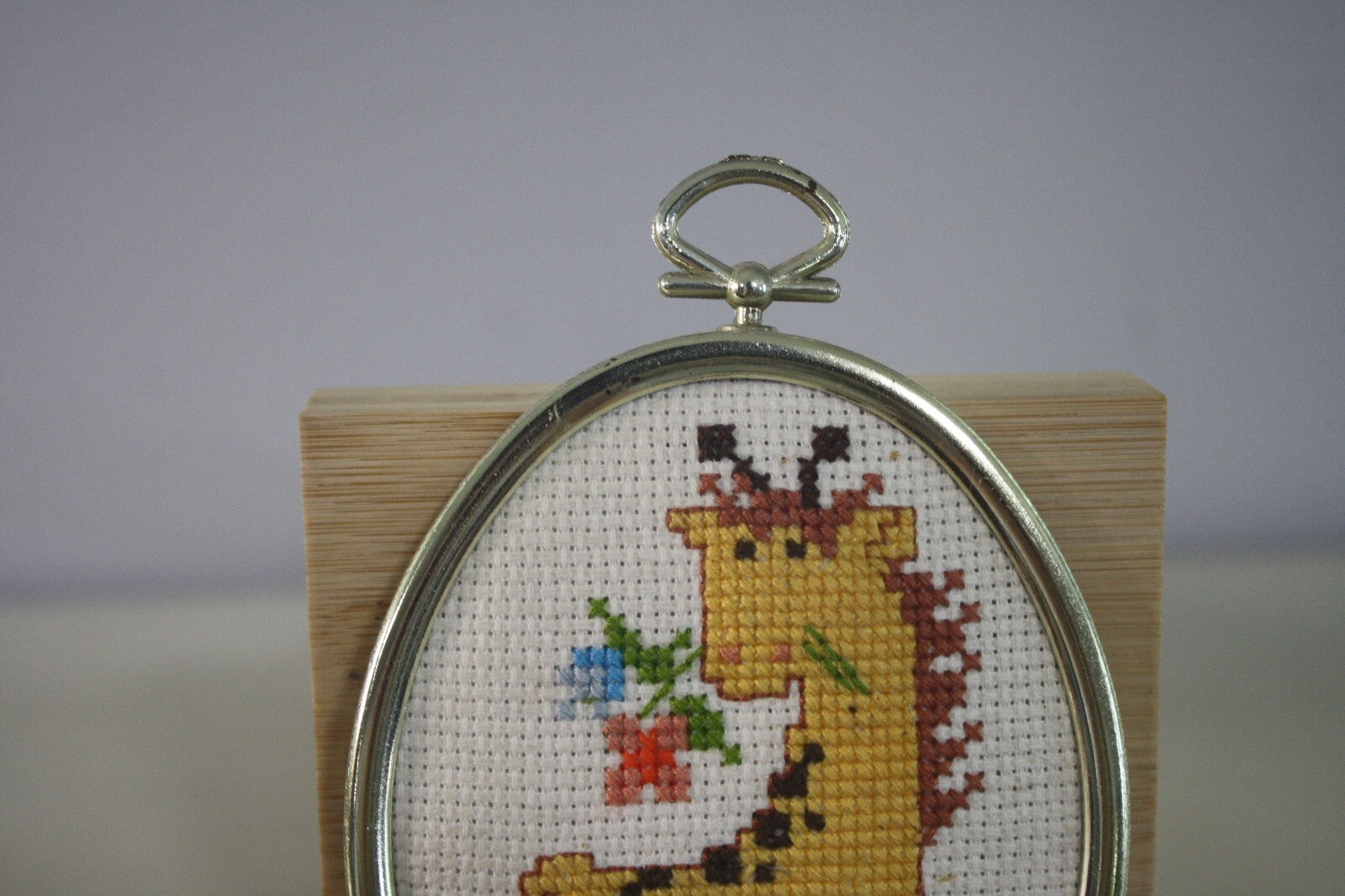 Handmade Cross Stitch Giraffe in Oval Silver Frame