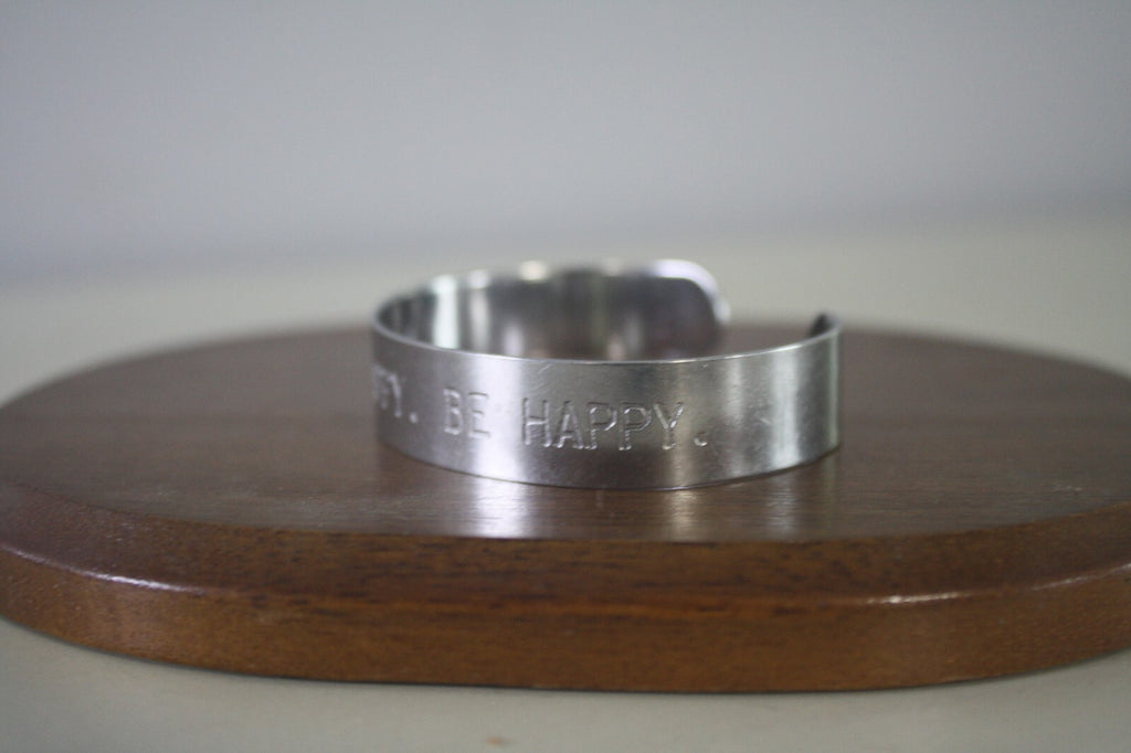 Adjustable Silver Metal Cuff Bracelet with Engraved 'THINK HAPPY. BE HAPPY.'