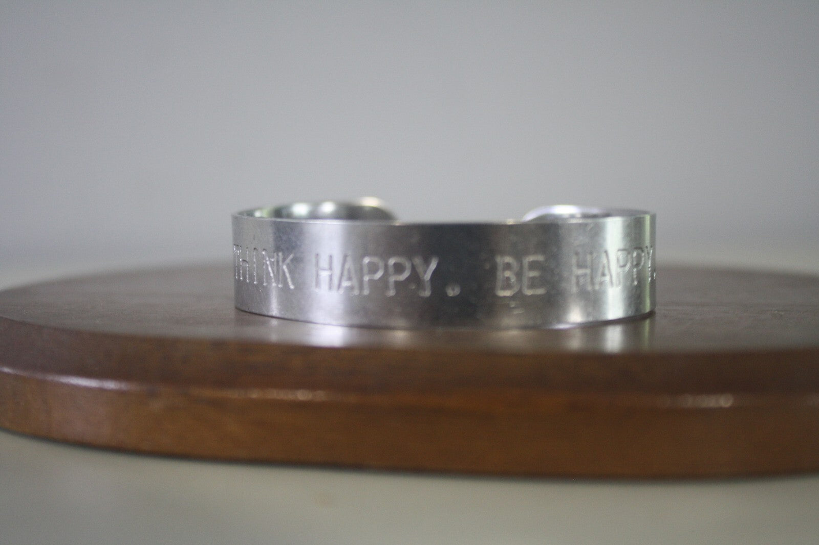 Adjustable Silver Metal Cuff Bracelet with Engraved 'THINK HAPPY. BE HAPPY.'